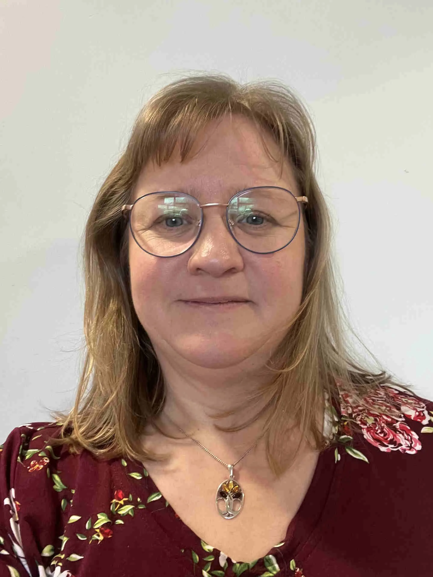 Photo of Susie wearing a red flowery top